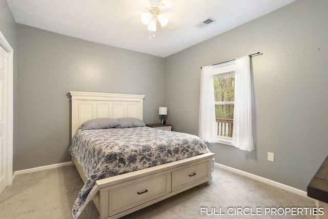 bedroom with light carpet, baseboards, and a ceiling fan