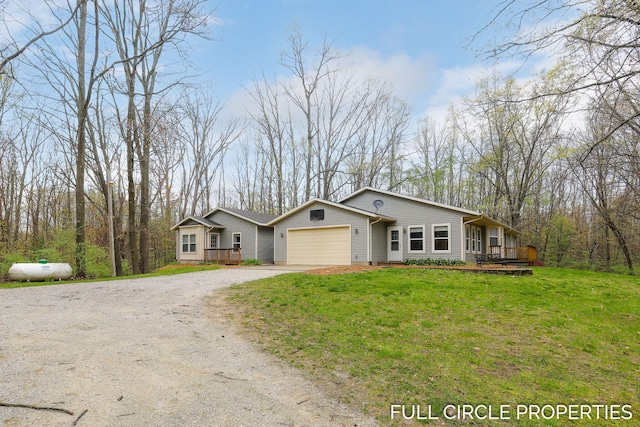 view of front of house with dirt driveway, an attached garage, a front yard, and a wooden deck