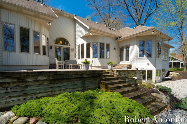 rear view of property featuring roof with shingles