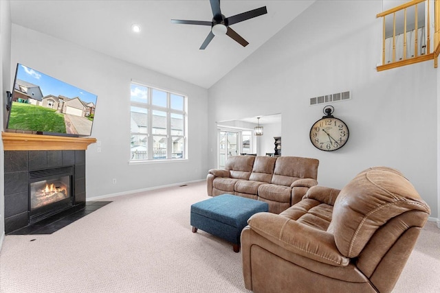 24231 Wilson Dr, Trenton, MI 48183 - living area featuring carpet flooring, high vaulted ceiling, baseboards, a ceiling fan, and a tiled fireplace