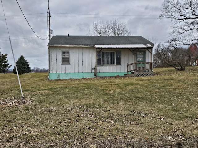 66660 Territorial Rd, Lawrence, MI 49064 - view of front of home featuring board and batten siding, a porch, a front yard, and a chimney