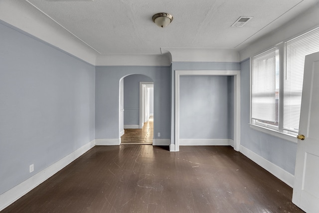 12346 Stoepel St, Detroit, MI 48204 - unfurnished room featuring arched walkways, wood finished floors, baseboards, and a textured ceiling