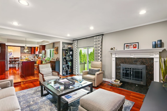 1438 Leafgreen Dr, Troy, MI 48083 - living room with ornamental molding, wood finished floors, a premium fireplace, and recessed lighting