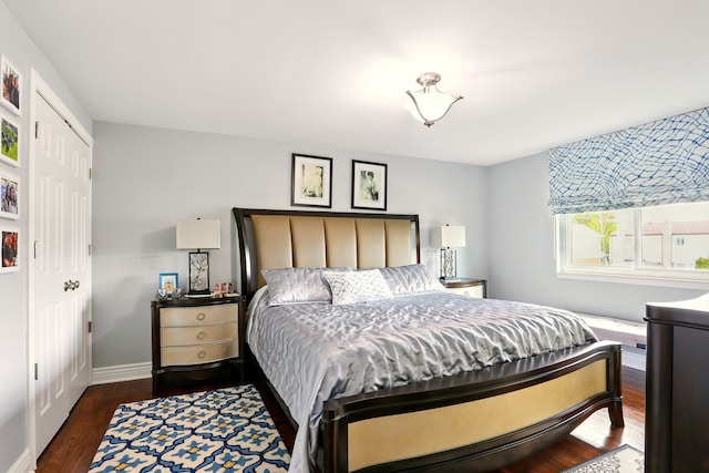 1438 Leafgreen Dr, Troy, MI 48083 - bedroom featuring dark wood-style flooring, a closet, and baseboards