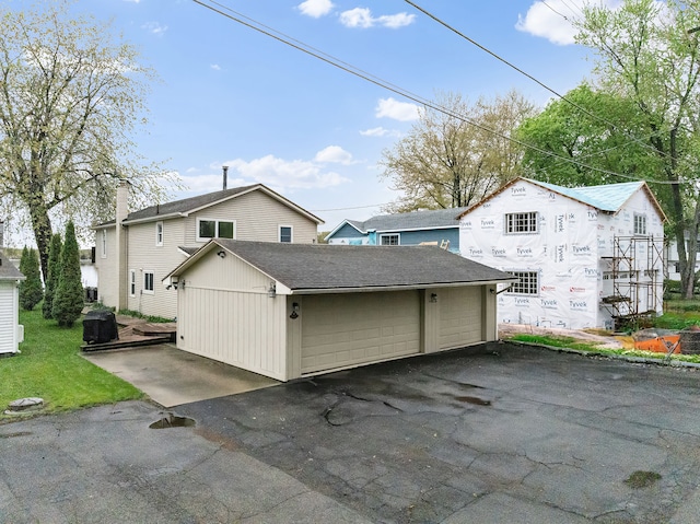 4825 Downing Dr, Pinckney, MI 48169 - view of property exterior featuring a shingled roof, a chimney, and an outdoor structure