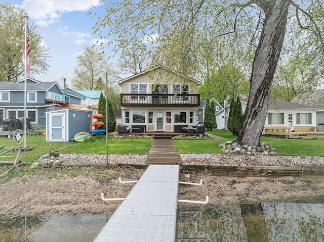 4825 Downing Dr, Pinckney, MI 48169 - back of house with a shed, an outdoor structure, a lawn, and a balcony