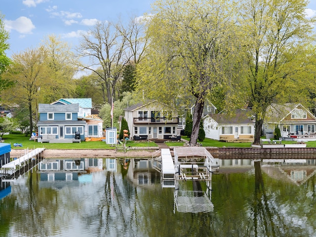 4825 Downing Dr, Pinckney, MI 48169 - dock area with a water view, boat lift, and a yard