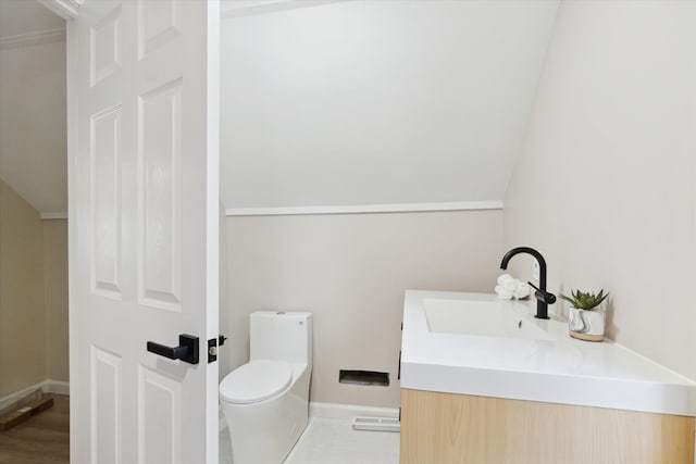 1077 E 14 Mile Rd, Clawson, MI 48017 - bathroom featuring toilet, vanity, baseboards, and lofted ceiling