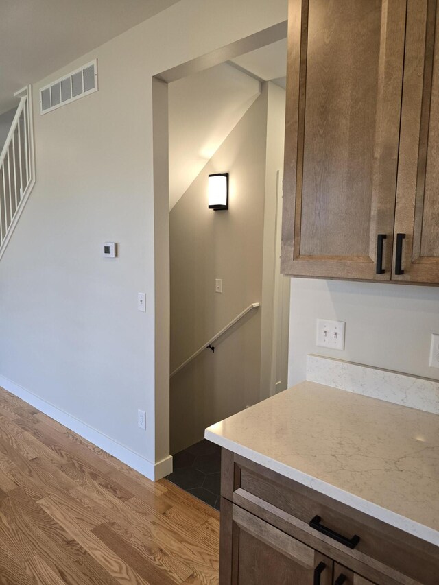 319 Sedgewood Ln, Ann Arbor, MI 48103 - kitchen featuring wood finished floors, light countertops, baseboards, and dark brown cabinetry