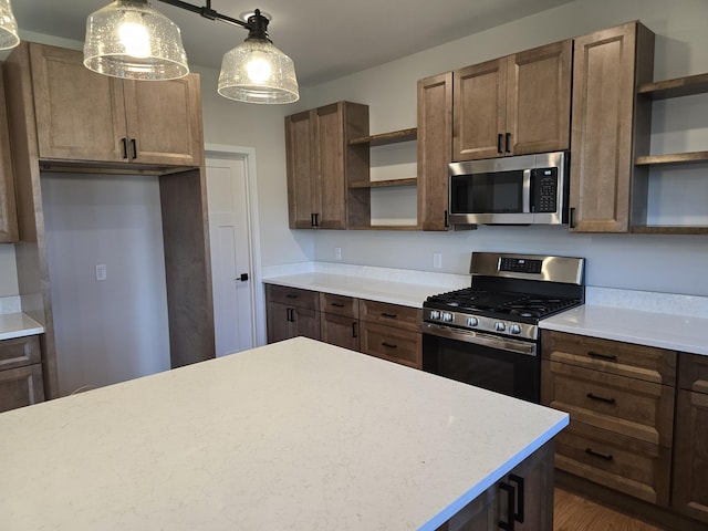 319 Sedgewood Ln, Ann Arbor, MI 48103 - kitchen featuring open shelves, stainless steel appliances, hanging light fixtures, and dark wood-type flooring