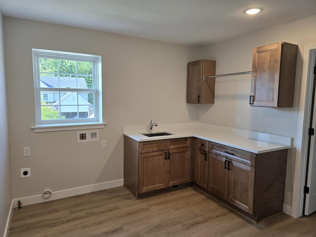 319 Sedgewood Ln, Ann Arbor, MI 48103 - laundry area with hookup for an electric dryer, light wood-style flooring, hookup for a washing machine, cabinet space, and baseboards