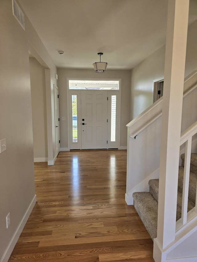 319 Sedgewood Ln, Ann Arbor, MI 48103 - entryway with baseboards, wood finished floors, and stairway