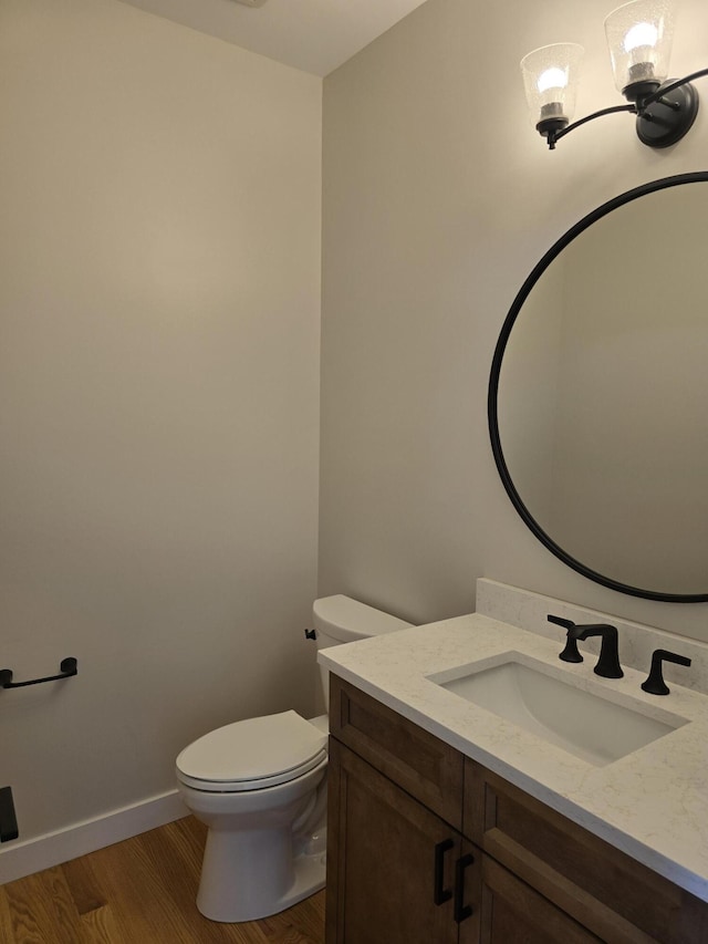 319 Sedgewood Ln, Ann Arbor, MI 48103 - half bath with vanity, toilet, wood finished floors, and baseboards