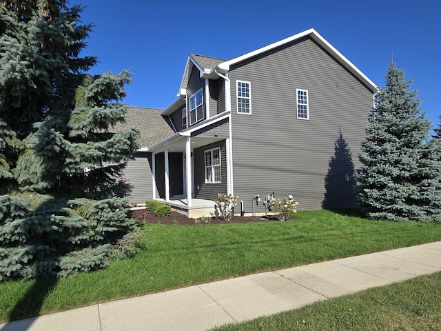 319 Sedgewood Ln, Ann Arbor, MI 48103 - view of property exterior with a porch, a lawn, and a shingled roof