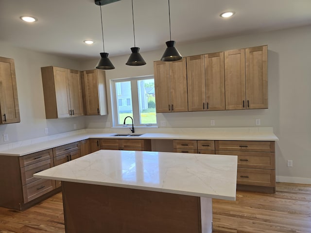 319 Sedgewood Ln, Ann Arbor, MI 48103 - kitchen with light wood finished floors, light stone counters, hanging light fixtures, recessed lighting, and a kitchen island