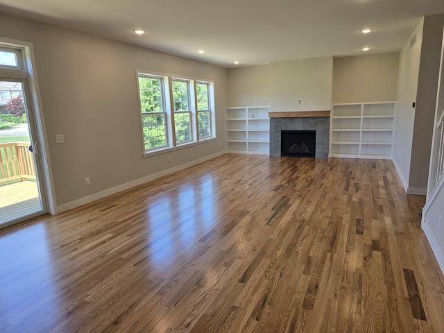 319 Sedgewood Ln, Ann Arbor, MI 48103 - unfurnished living room featuring wood finished floors, a fireplace, and recessed lighting