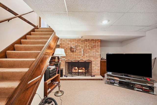 1888 N Sierra Way, Stevensville, MI 49127 - carpeted living room featuring a paneled ceiling, a brick fireplace, and stairs