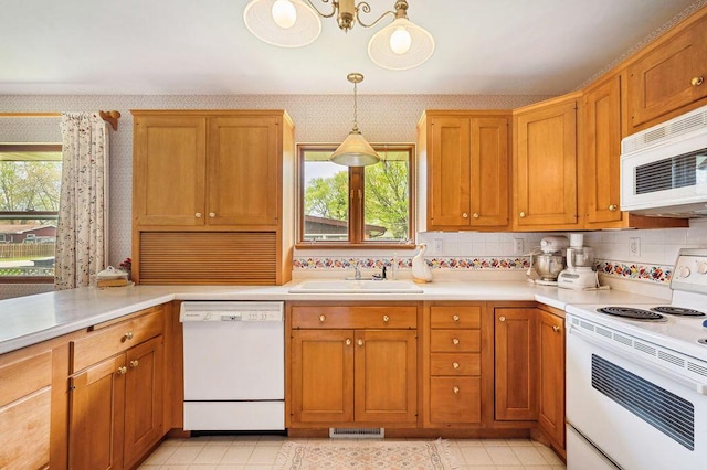1888 N Sierra Way, Stevensville, MI 49127 - kitchen with white appliances, a sink, healthy amount of natural light, wallpapered walls, and light countertops