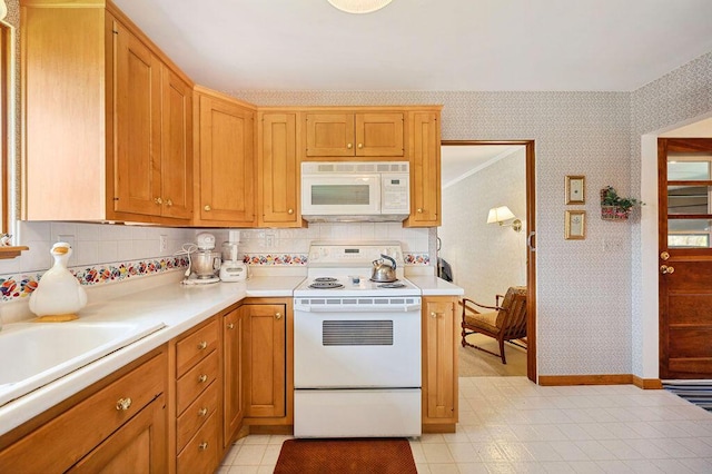 1888 N Sierra Way, Stevensville, MI 49127 - kitchen with white appliances, wallpapered walls, light countertops, baseboards, and backsplash