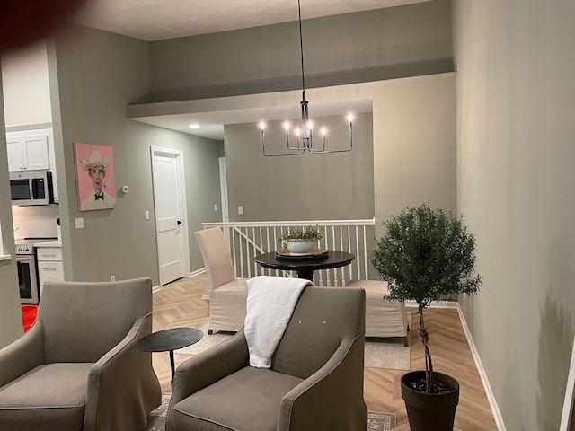dining space featuring a chandelier, baseboards, and parquet floors