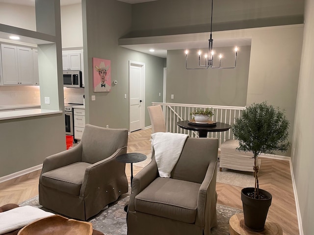 dining room featuring baseboards, a chandelier, and a high ceiling