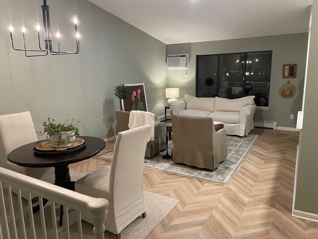 living room featuring a chandelier, a baseboard radiator, a wall unit AC, and baseboards