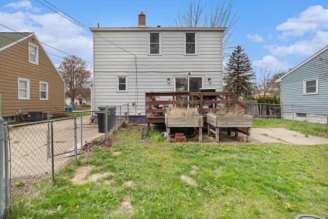 2682 Pinehurst Rd, Norton Shores, MI 49441 - back of house featuring a chimney, a wooden deck, and central AC