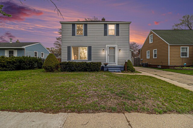 2682 Pinehurst Rd, Norton Shores, MI 49441 - view of front facade featuring a chimney and a lawn