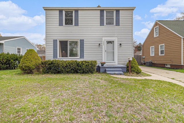 2682 Pinehurst Rd, Norton Shores, MI 49441 - view of front of home with a front lawn and central air condition unit