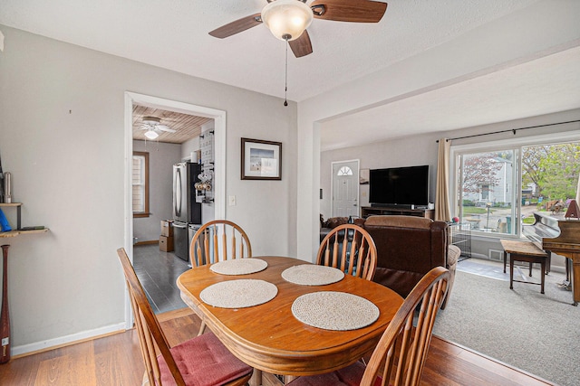 2682 Pinehurst Rd, Norton Shores, MI 49441 - dining room featuring a ceiling fan, wood finished floors, and baseboards