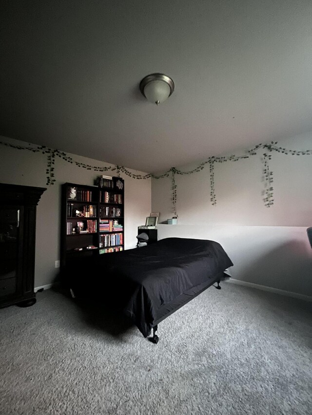carpeted bedroom featuring baseboards