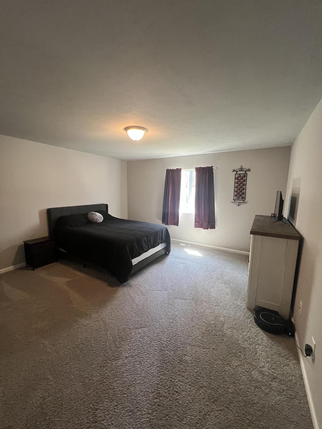 carpeted bedroom featuring baseboards