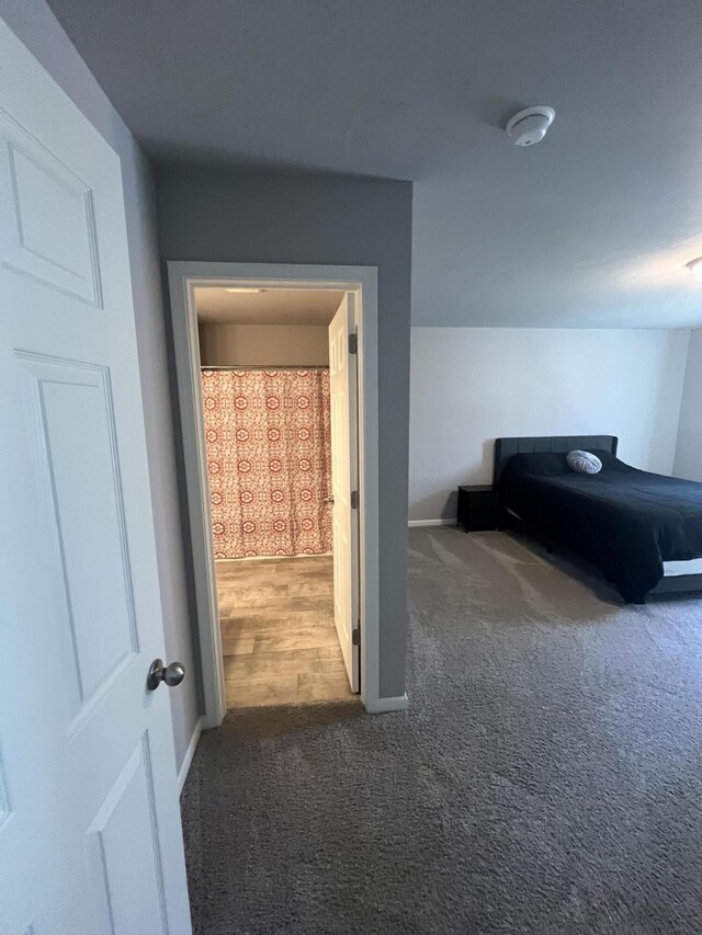 corridor with carpet floors and baseboards