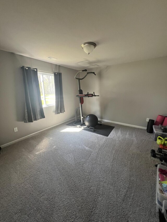 exercise area featuring carpet floors and baseboards