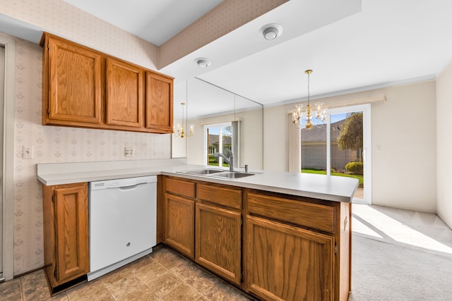 kitchen featuring white dishwasher, a chandelier, a sink, a peninsula, and wallpapered walls