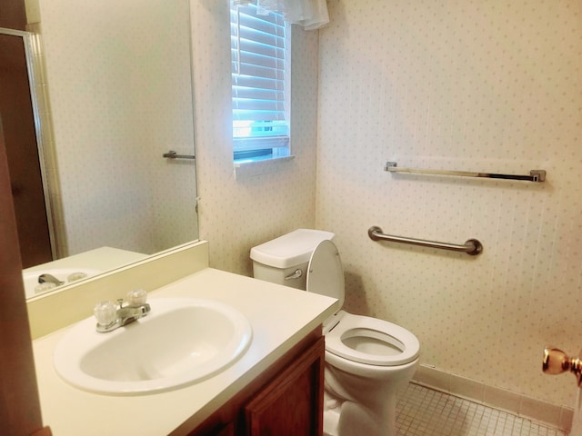 full bath featuring tile patterned floors, toilet, vanity, an enclosed shower, and baseboards