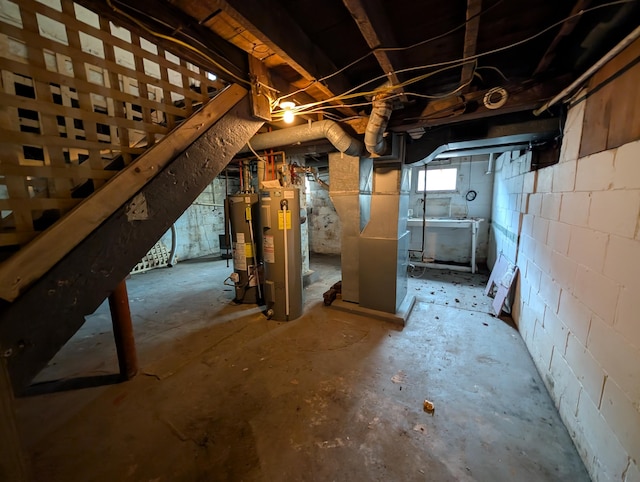 below grade area featuring water heater and heating unit