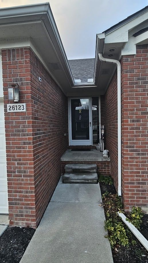 26123 Joanne Smith Ln, Chesterfield, MI 48051 - doorway to property featuring brick siding