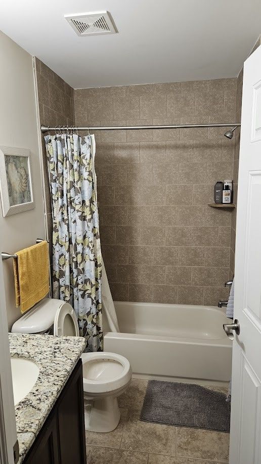 26123 Joanne Smith Ln, Chesterfield, MI 48051 - bathroom with shower / bath combo, tile patterned floors, toilet, and vanity