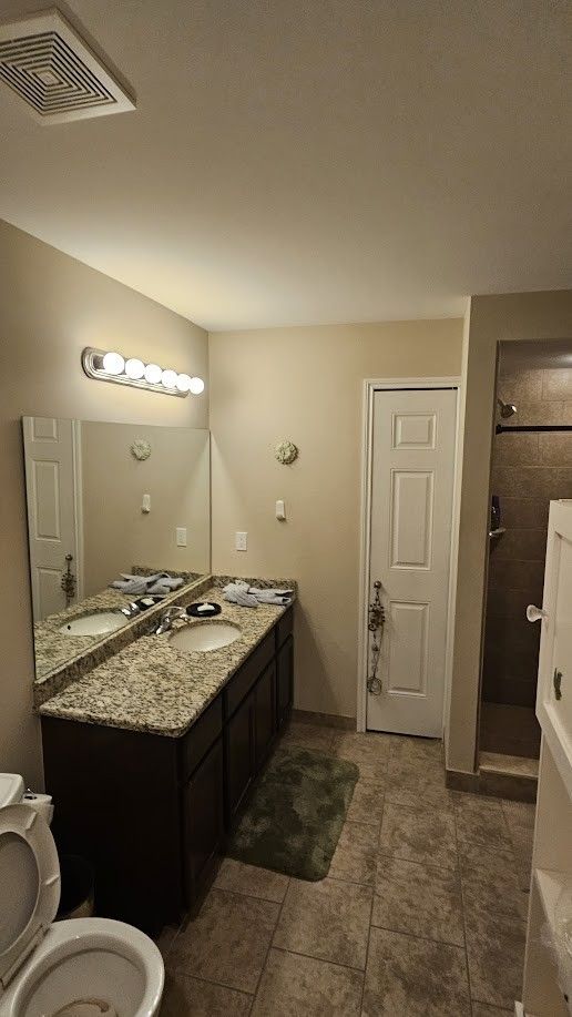 26123 Joanne Smith Ln, Chesterfield, MI 48051 - full bath featuring a shower stall, vanity, toilet, and tile patterned flooring
