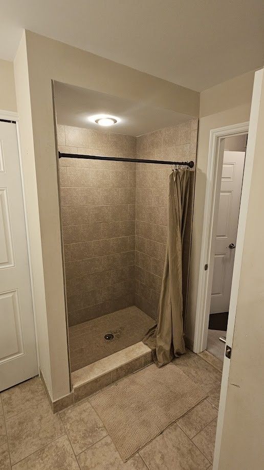 26123 Joanne Smith Ln, Chesterfield, MI 48051 - bathroom featuring a stall shower and tile patterned flooring
