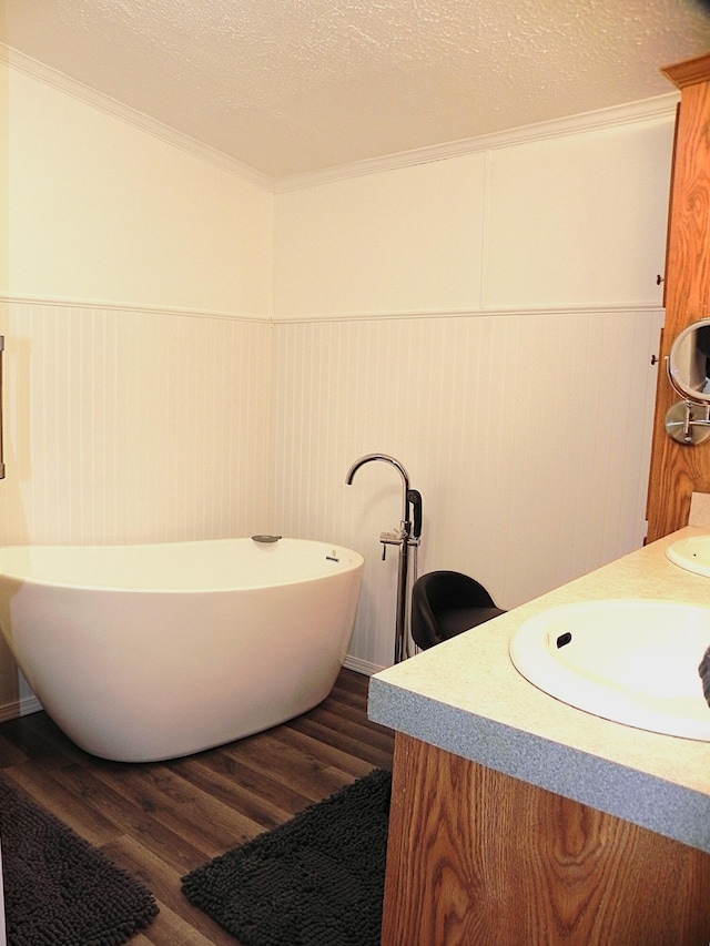 1232 Shiawassee River Rd, Three Rivers, MI 49093 - bathroom featuring wood finished floors, crown molding, a freestanding tub, a wainscoted wall, and vanity