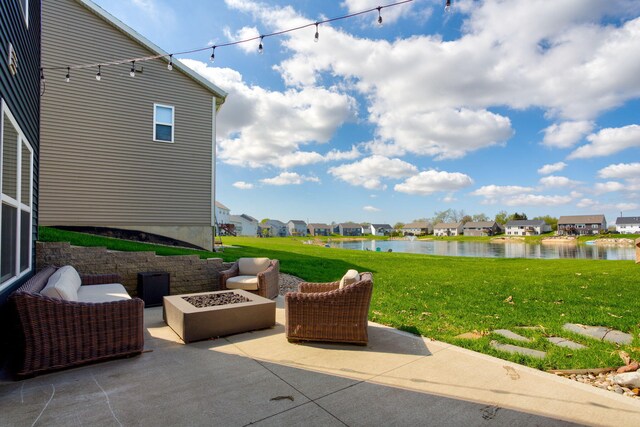 view of patio / terrace featuring a water view, an outdoor fire pit, and a residential view