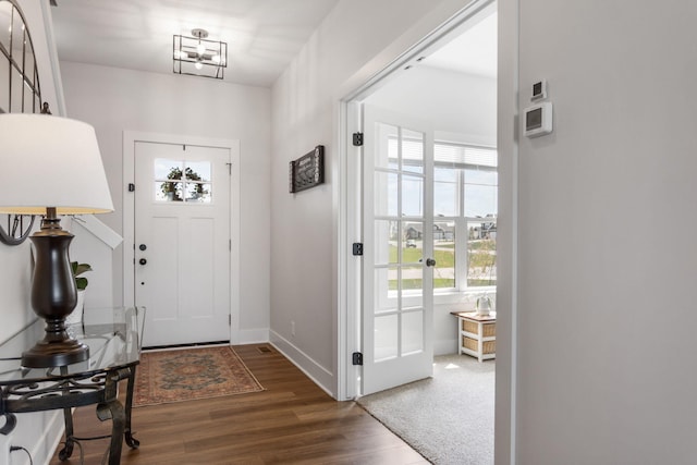 entrance foyer with wood finished floors and baseboards