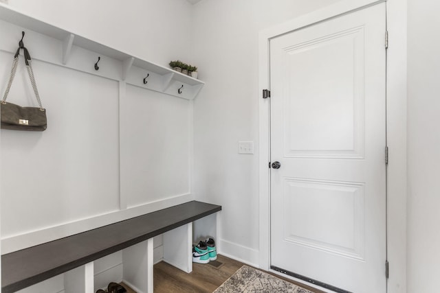 mudroom featuring dark wood finished floors and baseboards