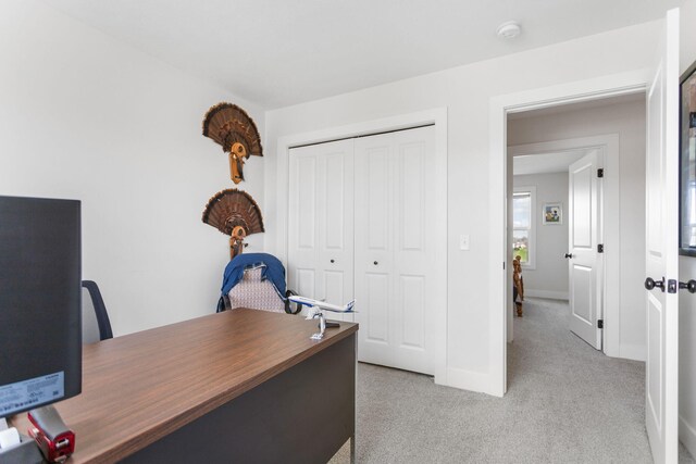 home office featuring light colored carpet and baseboards