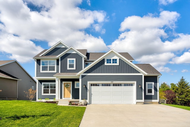 craftsman house featuring board and batten siding, concrete driveway, a garage, and a front yard