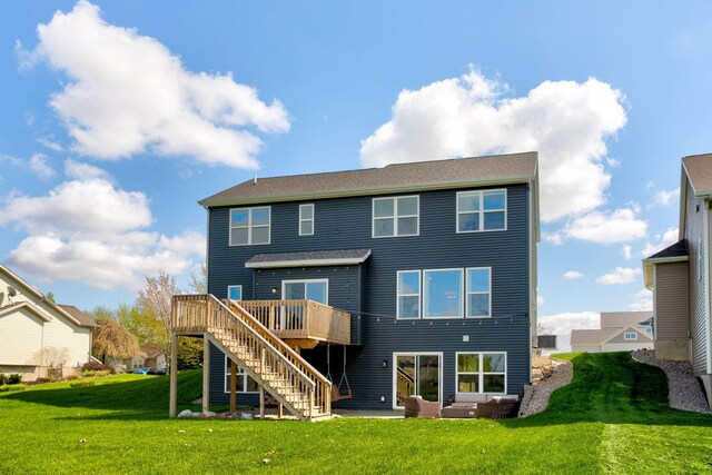 back of house featuring stairs, a deck, and a lawn