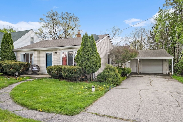 view of front of home featuring a front yard, a chimney, brick siding, and a shingled roof