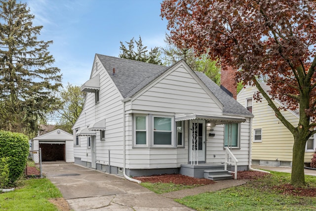 bungalow featuring an outdoor structure, a shingled roof, driveway, a garage, and a chimney